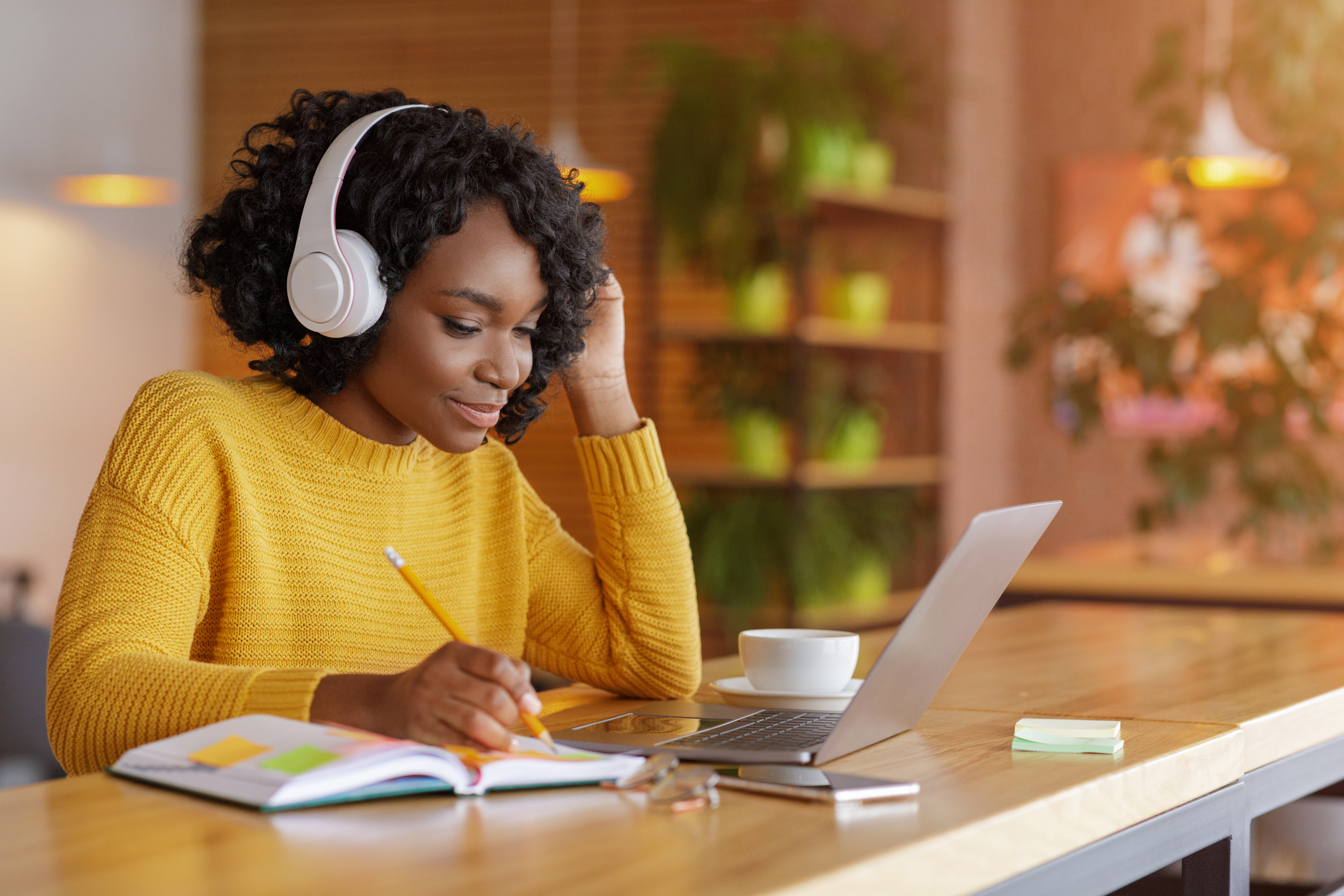 A prospective RBT studies while taking a self-paced video training session from her laptop in an open, airy common area.