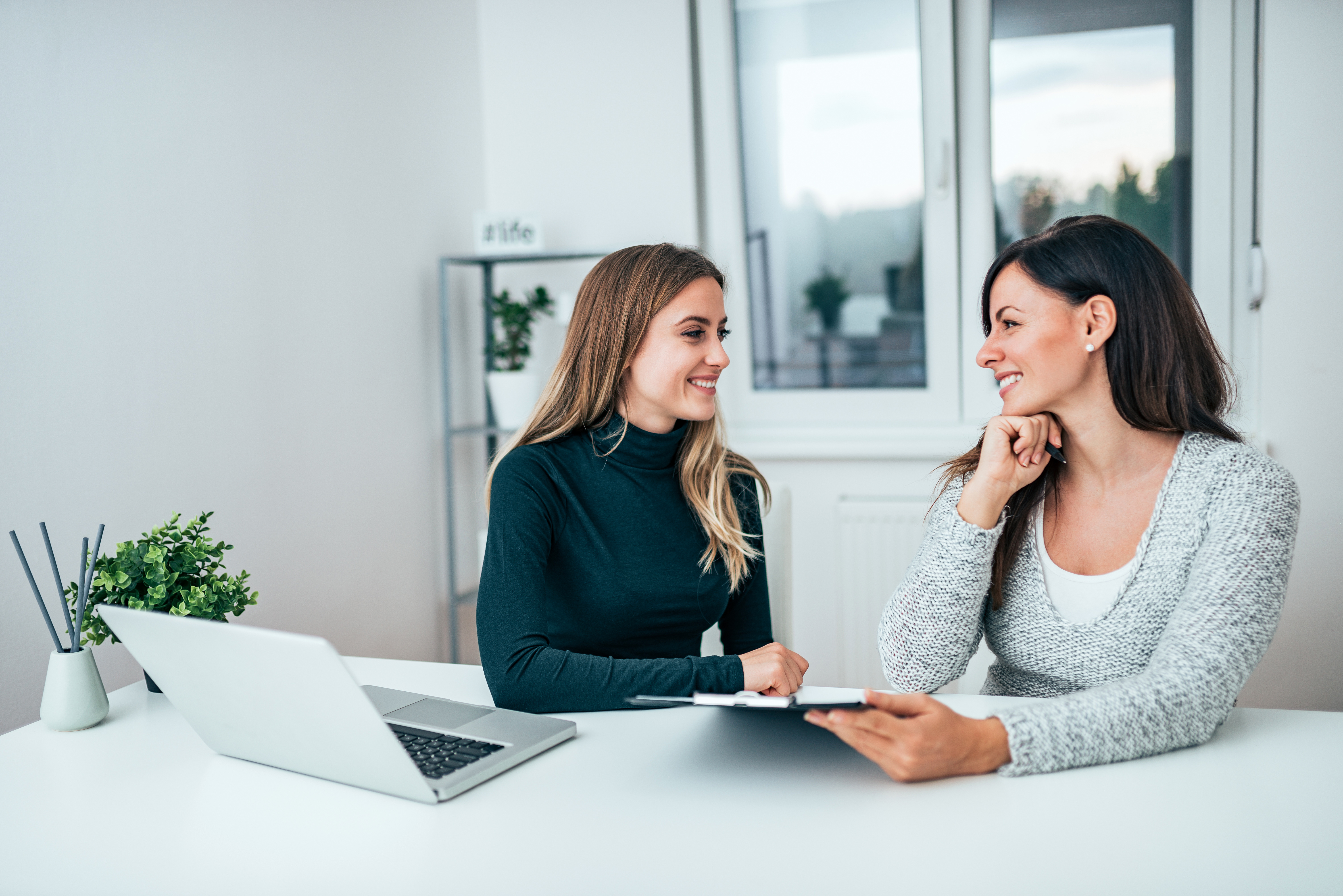 A mentor explains a complicated subject to a prospective RBT in her office.