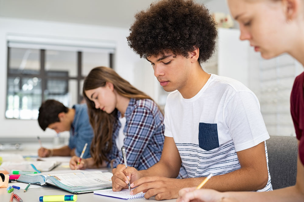 Students quietly complete a test with pencil and paper.